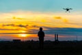 Drone over the Village at cloudy Sunset with his Pilot Royalty Free Stock Photo