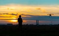 Drone over the Village at cloudy Sunset with his Pilot Royalty Free Stock Photo