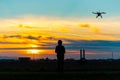 Drone over the Village at cloudy Sunset with his Pilot