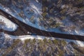 Drone panorama from above of a forest with snow capped trees and car being towed by another one on the road