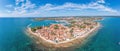 Drone panorama over the Croatian coastal town Novigrad with harbor and promenade taken from the sea side during the day