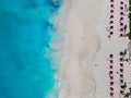 Drone photo of beach with red umbrellas in Grace Bay, Providenciales, Turks and Caicos