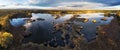 A drone photo of lake - pond bog with sun - Absolutely stunning aerial landscape sunset panorama Royalty Free Stock Photo