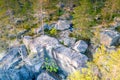 Drone photo of Northern Scandinavian forest in rocky mountains, big stones, yellow green trees at the end of summer - beginning of