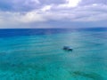 Drone photo of traditional fishermen boats in the blue and clear waters of Pulau Tabuhan, Banyuwangi, Indonesia Royalty Free Stock Photo