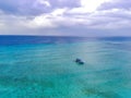 Drone photo of traditional fishermen boats in the blue and clear waters of Pulau Tabuhan, Banyuwangi, Indonesia Royalty Free Stock Photo