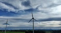 Drone photo of wind turbines at sunset in front of the AllgÃ¤u Alps