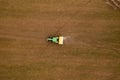 Drone photography of agricultural equipment working in field and spreading fertilizer Royalty Free Stock Photo