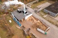 Drone photography of biomass power plant and biomass storage place during autumn day