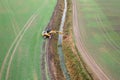 Drone photography of excavator cleaning drainage ditch in an agriculture field during autumn morning
