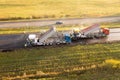 Drone photography of highway repair with heavy industrial machinery during autumn morning