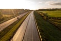 Drone photography of highway repair with heavy industrial machinery during autumn morning