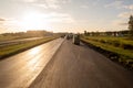 Drone photography of highway repair with heavy industrial machinery during autumn morning