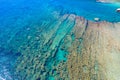 Aerial view of a rocky stone island in clear green blue sea, Greece Royalty Free Stock Photo