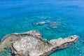 Aerial view of a rocky stone island in clear green blue sea, Greece Royalty Free Stock Photo