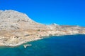 Aerial view of a rocky stone island in clear green blue sea, Greece Royalty Free Stock Photo