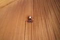 Drone photography of tractor with seeder working in field