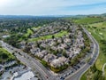 Drone photos over the Oakhurst neighborhood in Clayton, California with green hills, golf course and homes