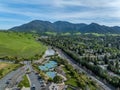 Drone photos over the Oakhurst neighborhood in Clayton, California with green hills, golf course and homes