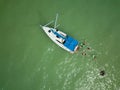 Drone pictue about a sailing ship from above. Green water, and people enjoy bathing together.