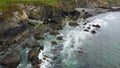 Drone point of view. Tidal waves of the Atlantic Ocean near coast of the island of Ireland. Rocky seashore. Seascape, top view