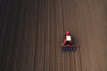 Drone pov tractor sowing corn in field