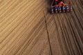 Drone pov tractor sowing corn in field