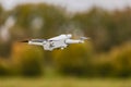 Drone with propeller, battery and camera flying over a meadow Royalty Free Stock Photo