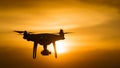 Drone quad copter with digital camera at sunset ready to fly for