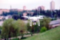 Drone quad copter with high resolution digital camera flying hovering over the city. Royalty Free Stock Photo