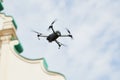 Drone quadcopter with digital camera hovering over city Royalty Free Stock Photo