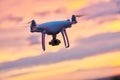 Drone quadcopter with digital camera flying at sunset Royalty Free Stock Photo