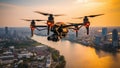 Drone quadcopter with digital camera flying over the city at sunset