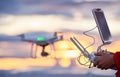 Drone quadcopter with digital camera flying at sunset Royalty Free Stock Photo