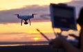 Drone quadcopter with digital camera flying at sunset Royalty Free Stock Photo