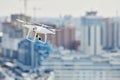 Drone quadcopter with digital camera hovering over city Royalty Free Stock Photo