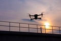 Drone quadcopter flying at sunset Royalty Free Stock Photo