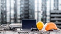 Drone, remote control, laptop and helmet at construction site Royalty Free Stock Photo