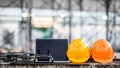 Drone, remote control, laptop and helmet at construction site Royalty Free Stock Photo