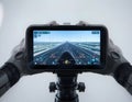 Drone Remote Controller Displaying Flight Path and Data on Highway Approach Royalty Free Stock Photo