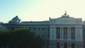 Drone rising above historic monument to reveal glorious national flag of Ukraine on adminitrative building on sunrise.