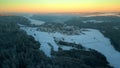 Drone rising up and towards snow covered village of Hausen, Germany