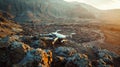 Drone on a rocky surface at sunset with mountains in the background