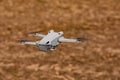 Drone with rotating rotors and camera cut out hovering over a field Royalty Free Stock Photo