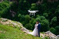 drone shoots wedding in mountains. newlyweds in mountain forest.