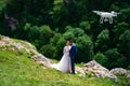 drone shoots wedding in mountains. newlyweds in mountain forest.