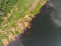 Drone shot aerial top view scenic landscape the fishing boat in a big river with fresh green tree
