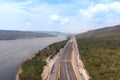 Drone shot aerial view landscape of under construction motorway tolls near big natural river Royalty Free Stock Photo