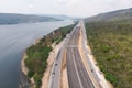 Drone shot aerial view landscape of under construction motorway tolls near big natural river Royalty Free Stock Photo