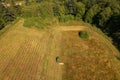 Aerial overhead view of a tractor mowing a hay field in preparation for baling. Royalty Free Stock Photo